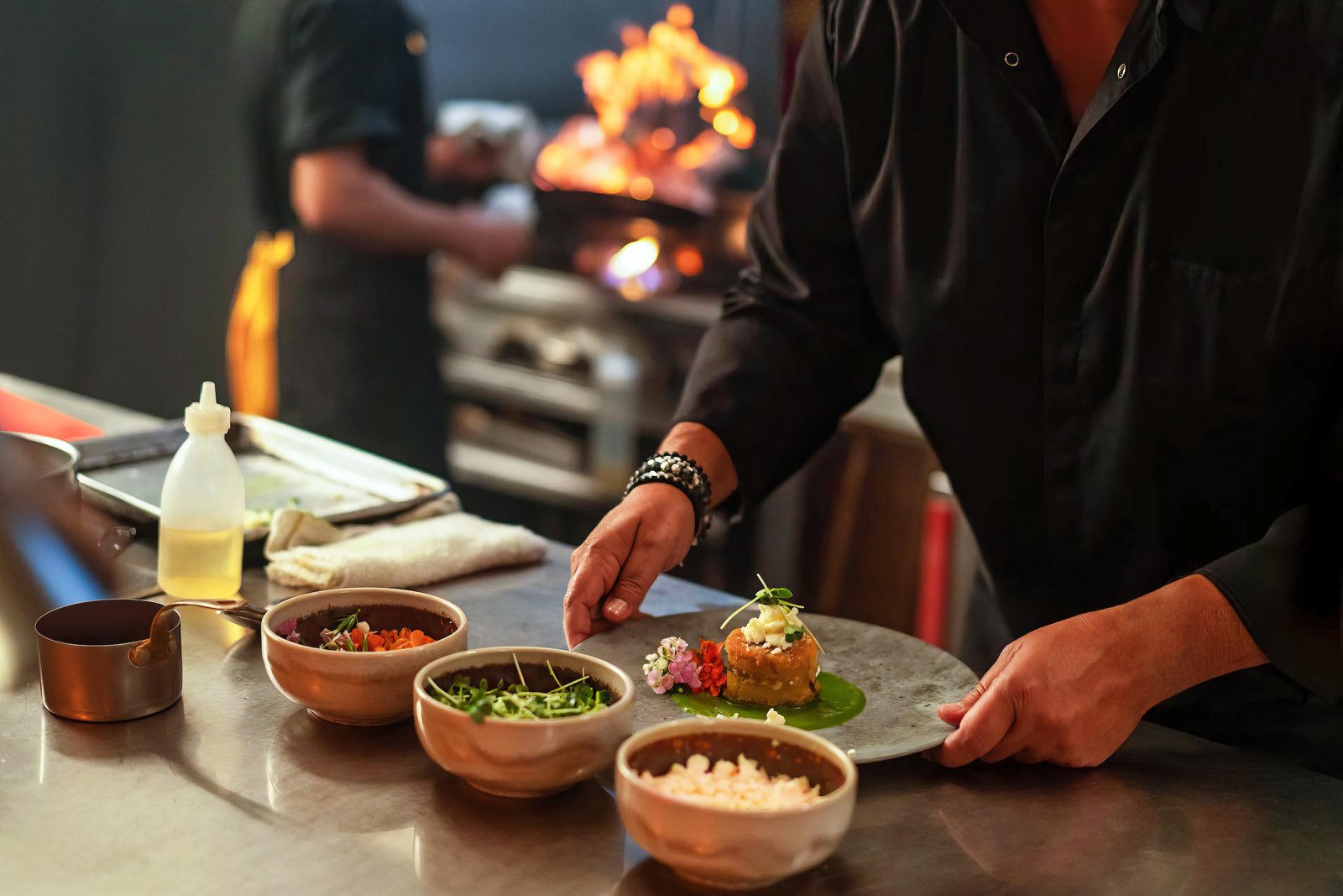 Chef Mario Pagán plating dishes.