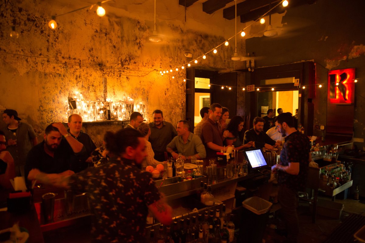 A packed bar under dim lights at La Factoria in Old San Juan.