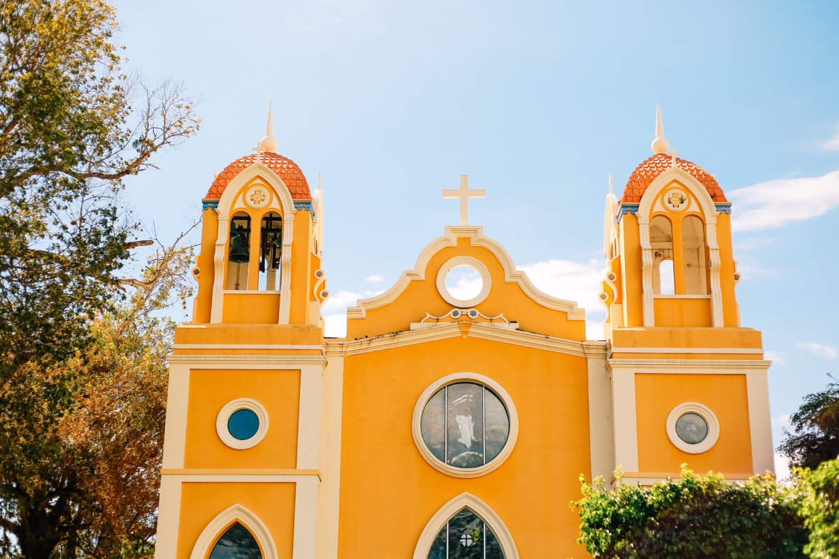 The bright yellow Spanish Mission-style church overlooking the town plaza in Anasco