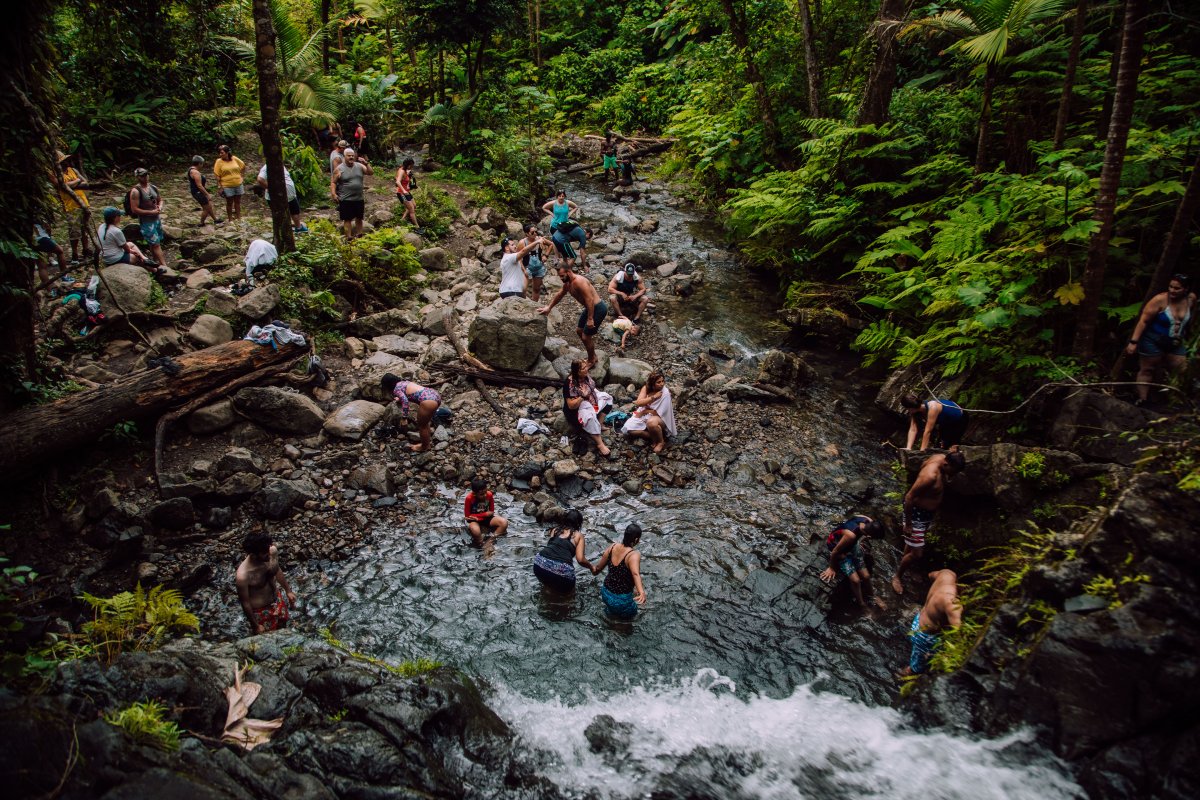 People enjoy the waterfall at Juan Diego Falls in El Yunque