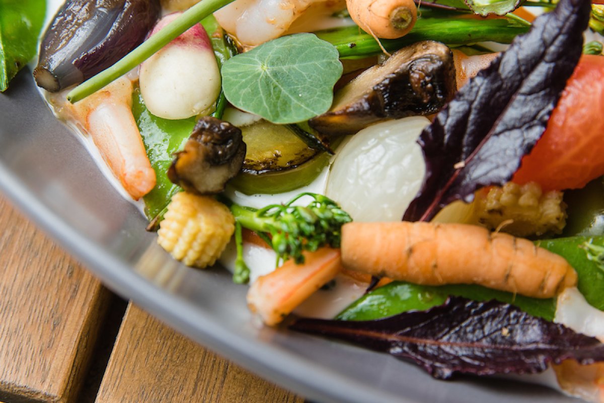 A plate with a spring salad from a vegan restaurant. 