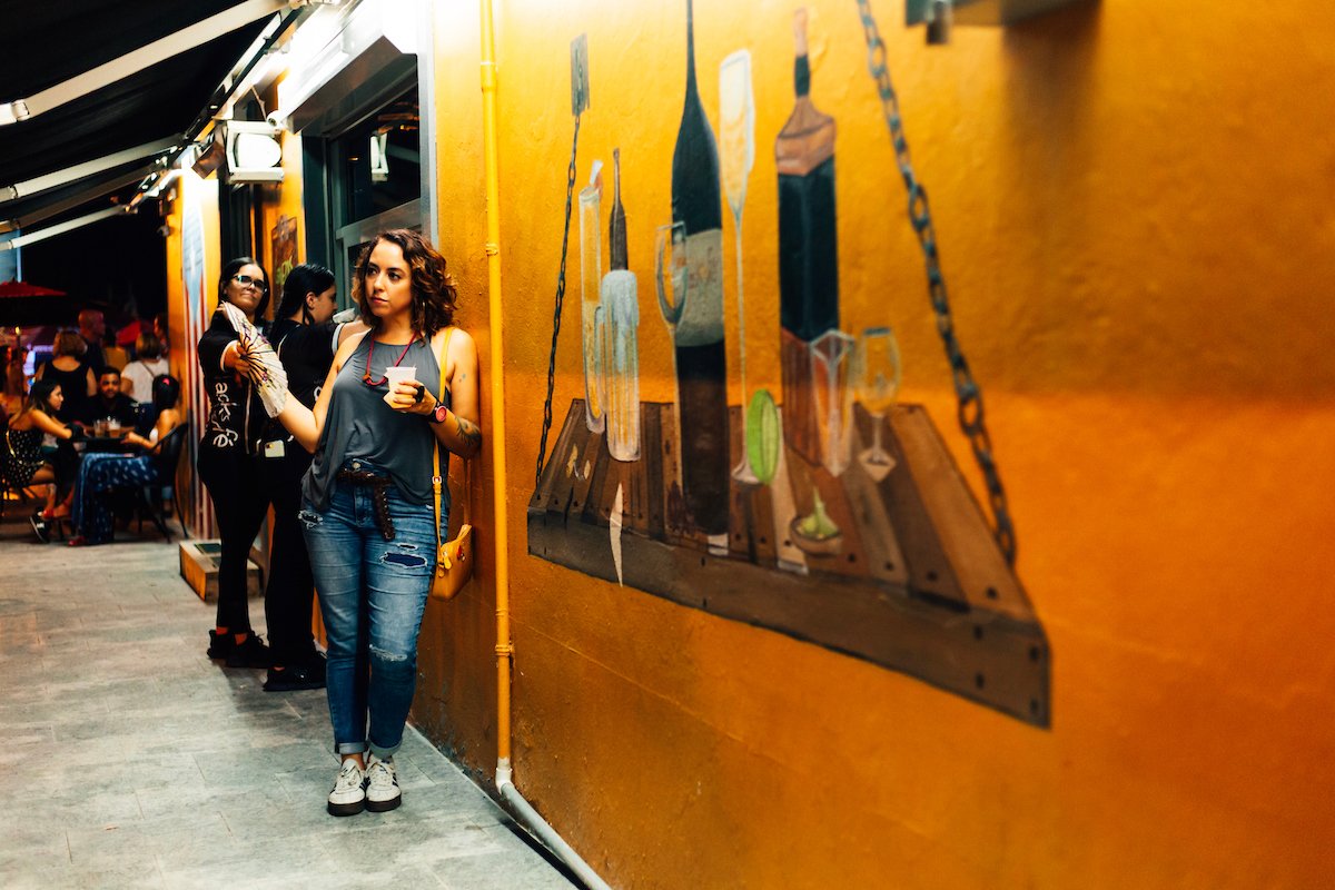 A candid street photograph of people enjoying nightlife in Caguas.