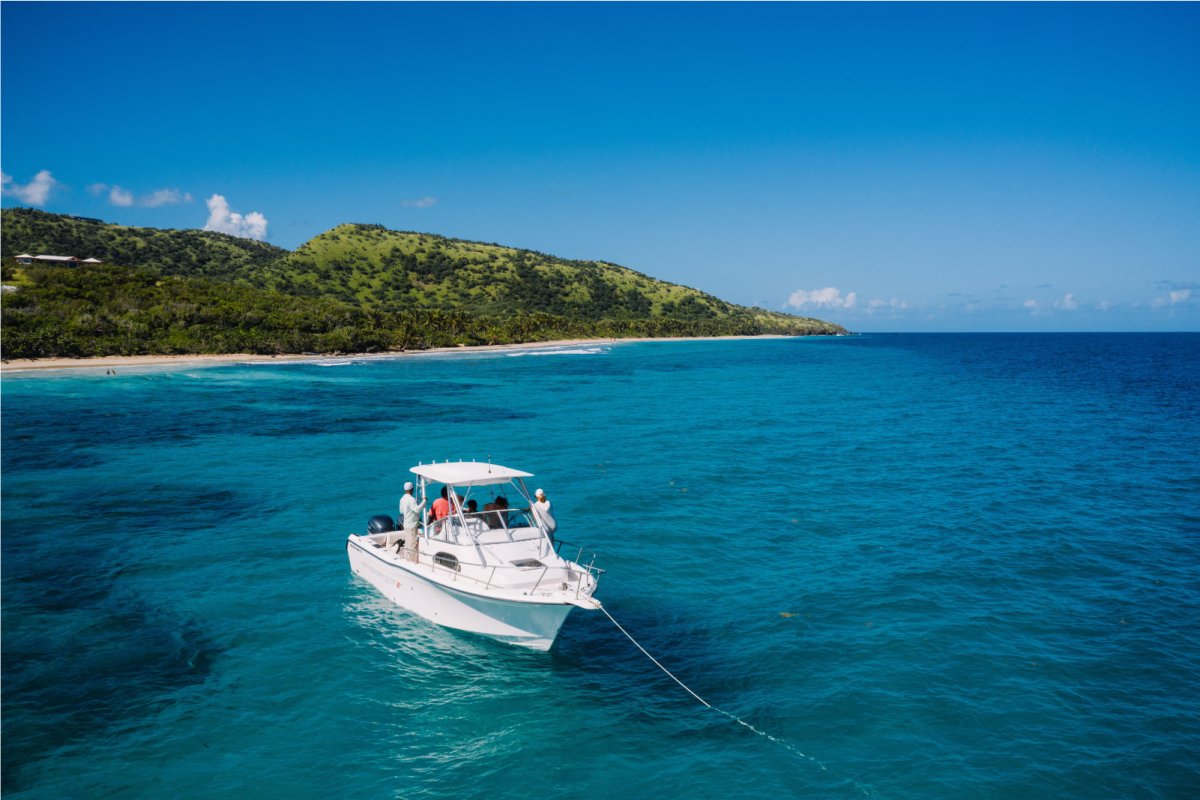 A boat is anchored off a beautiful beach in Puerto Rico