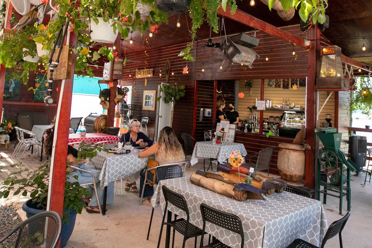 People sip coffee on an outdoor terrace at the Museo del Cafe de Puerto Rico in Ciales.