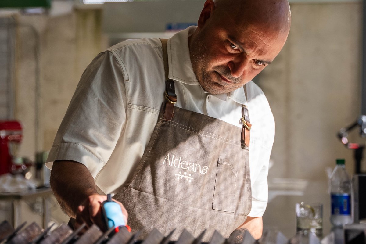 Chef Raul Correa preparing a dish in Aldeana