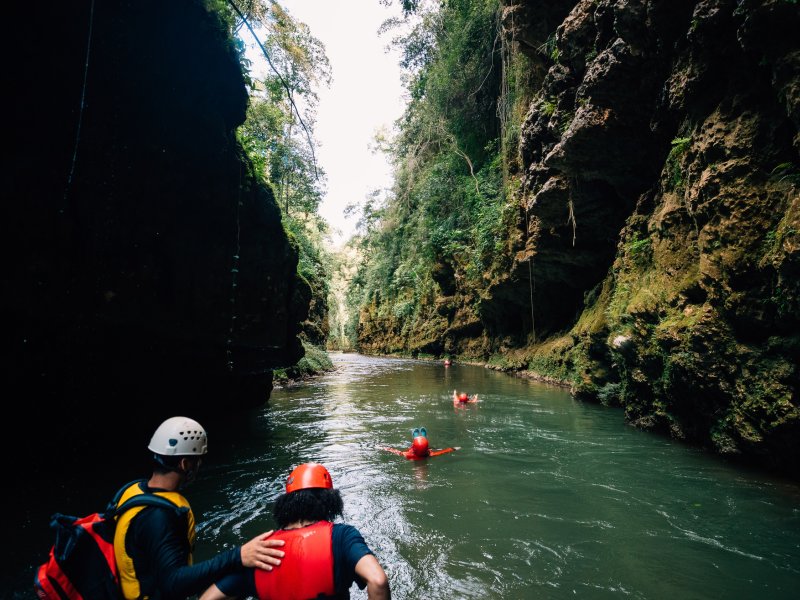 A group navigates the underground Tanama River in Utuado.