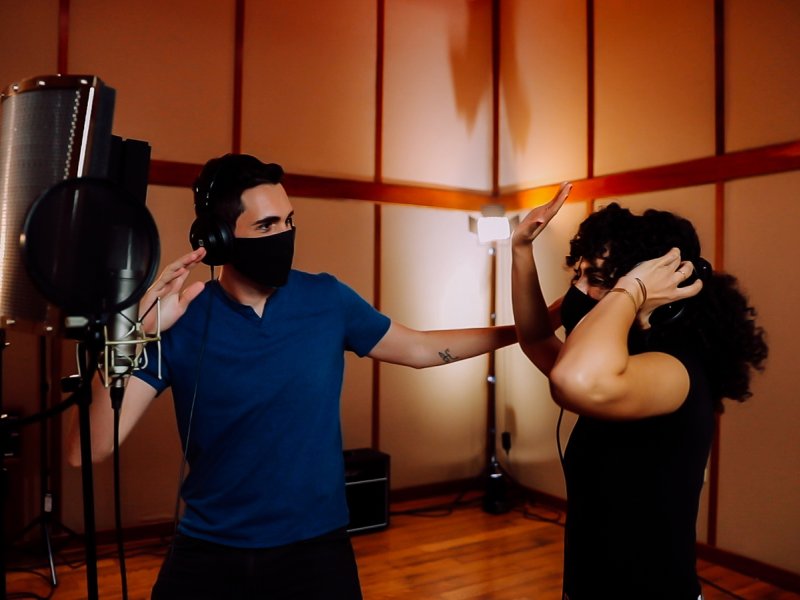 Una pareja disfrutando de la música reggaeton en un estudio.