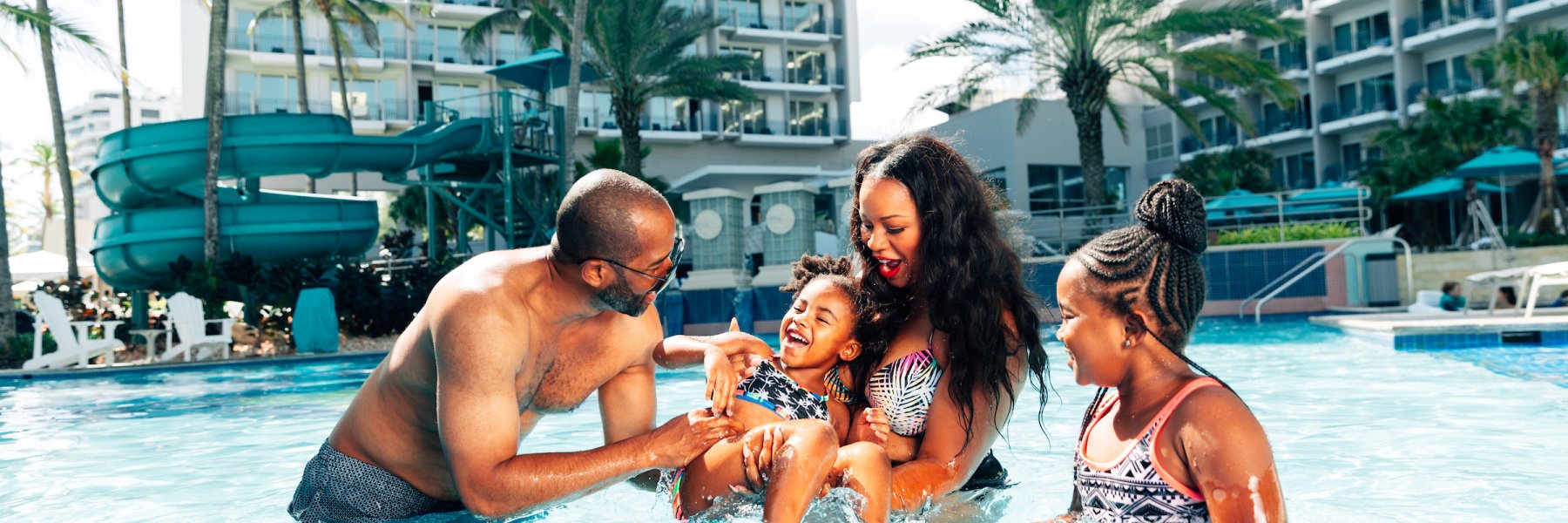 Family in resort pool.