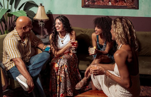 Group of people laughing on a couch.