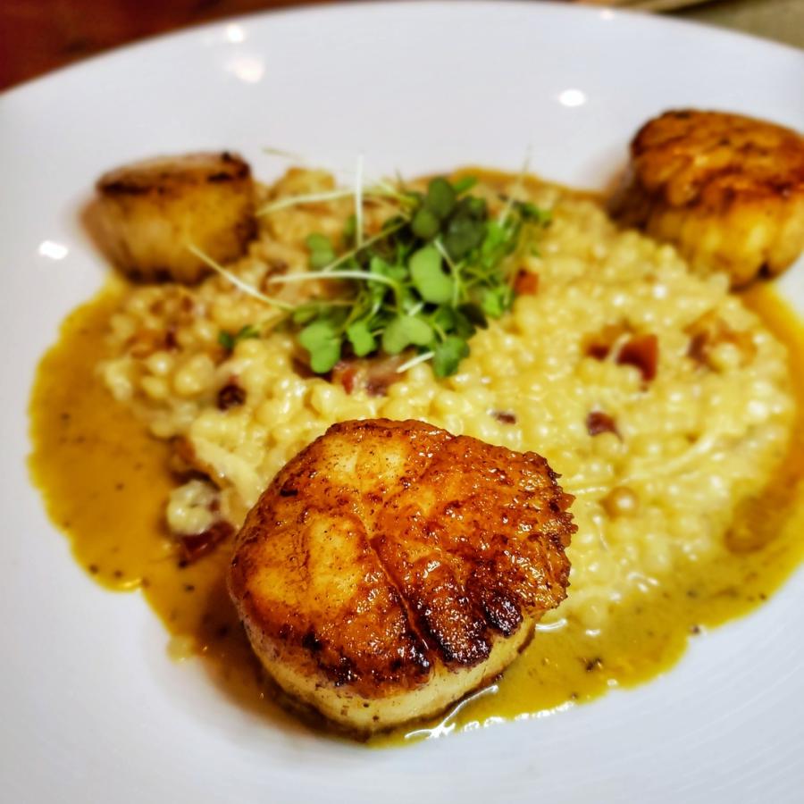 a beautiful dish featuring seared scallops at santaella restaurant in san juan