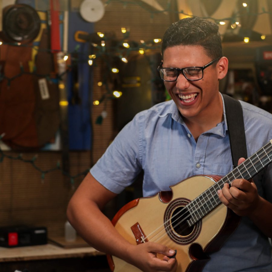 a man playing the cuatro, Puerto Rico's national instrument. 