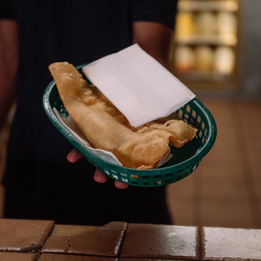 A server at Pastelillos Lamboy in Manati holds out a basket of pastelillos.