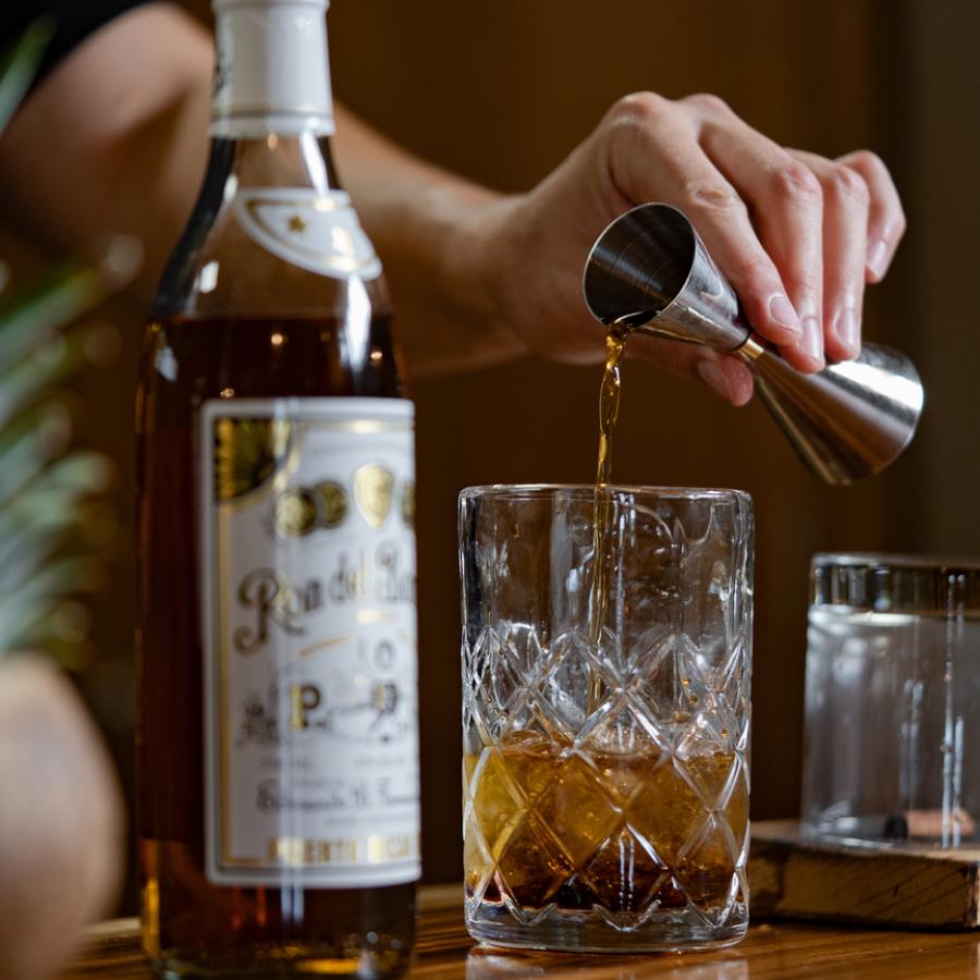 A measured pour of dark rum from Ron del Barrilito