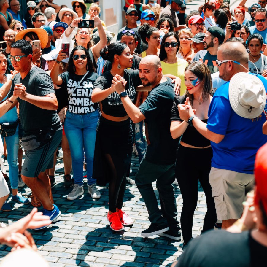 A large group of people salsa in the streets of Old San Juan, Puerto Rico