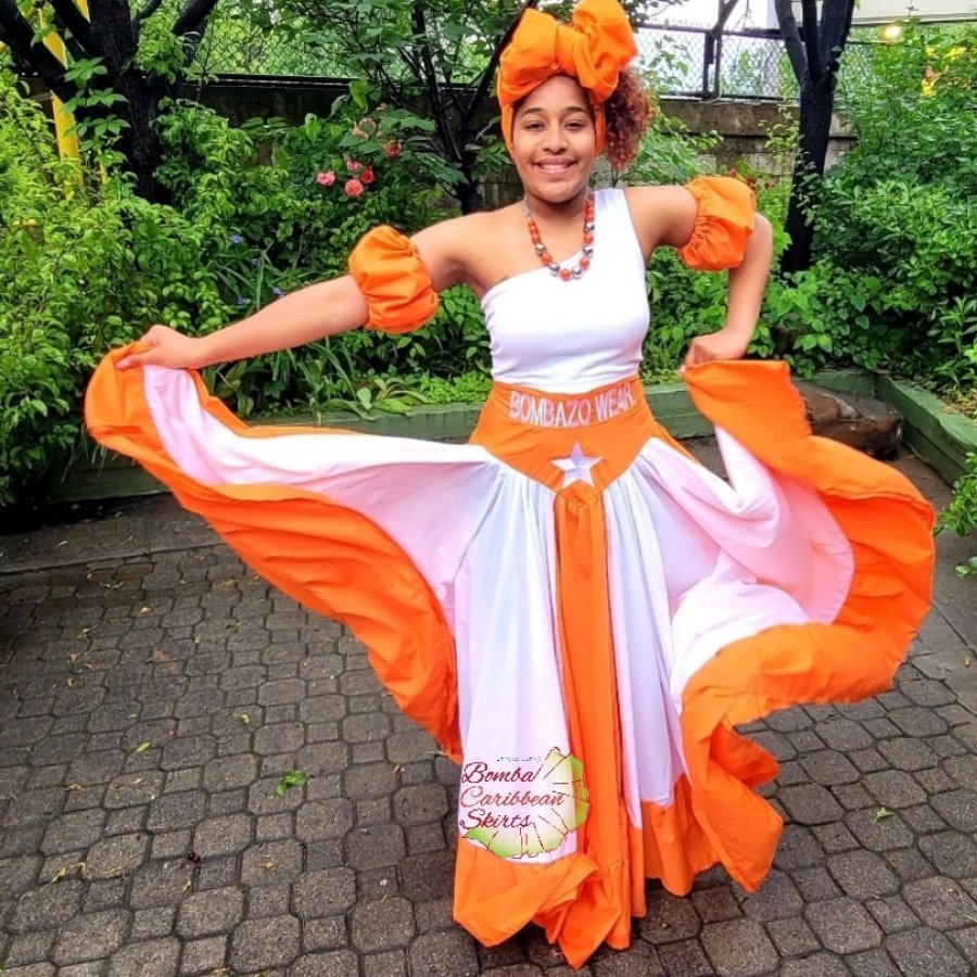 A woman in traditional bomba garb displays her skirt in shades of Puerto Rico Sunshine.