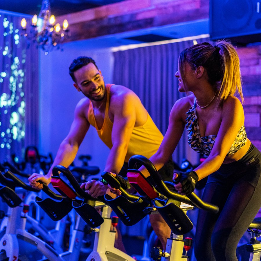 Men and woman in cycling class.