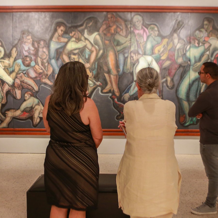 People admire a great painting in a museum