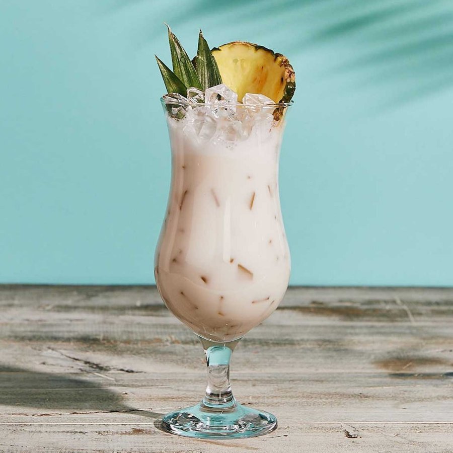 A coconut-based mocktail rests on a table. 