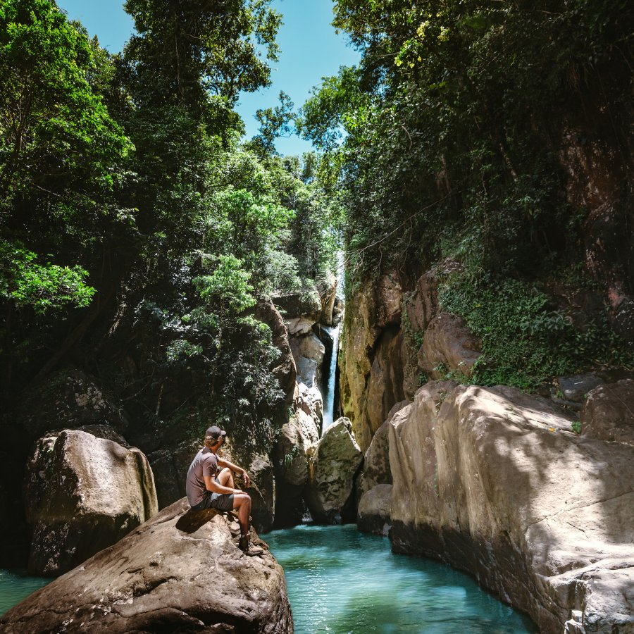 Man in front of waterfall.