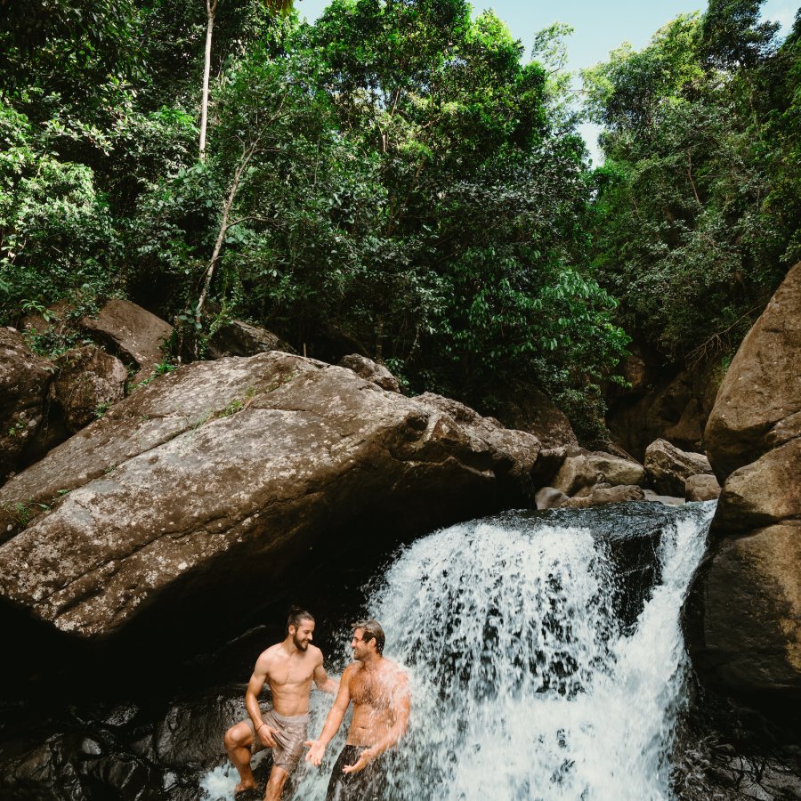 Two men in a waterfall at El Yunque.