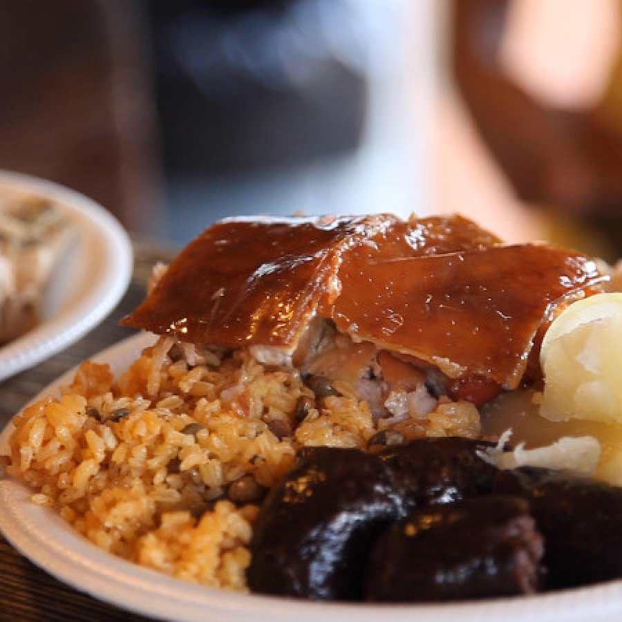 View of a traditional Puerto Rican holiday dish filled with rice and pigeon peas and lechón asado.