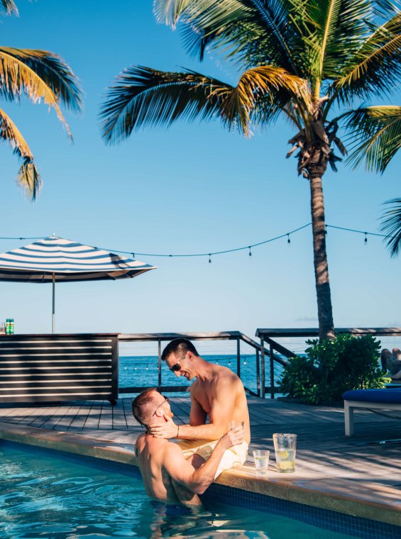 A couple relaxing poolside.