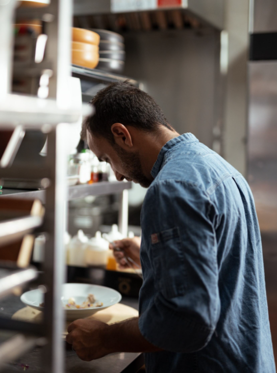 Rafael Ubior crafts a plate in his kitchen